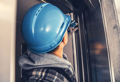 Close-up of manual worker checking elevator