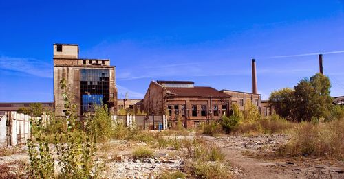 Abandoned building against blue sky