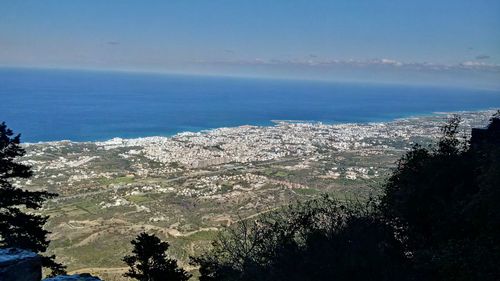 High angle view of sea and mountains against sky