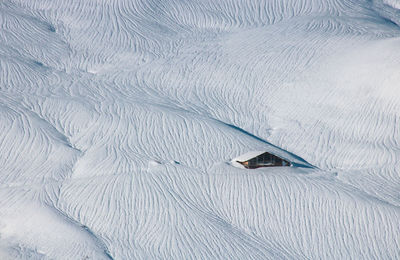 High angle view of snow and chalet on land