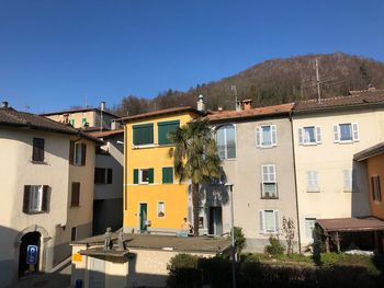 Residential buildings against clear blue sky