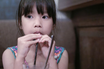 Close-up of girl sipping 
