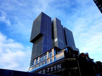 Low angle view of modern building against blue sky