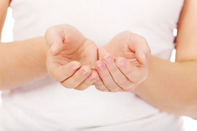 Midsection of woman cupping hands