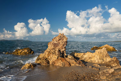 Panoramic view of rocks on beach against sky