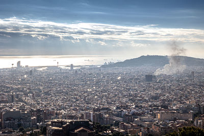 High angle view of city against cloudy sky