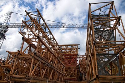 Low angle view of crane against sky