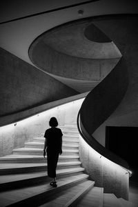 Rear view of man walking on steps