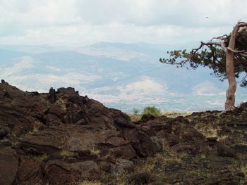 Scenic view of mountains against cloudy sky