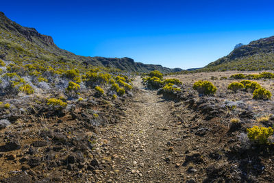 Scenic view of mountains against clear blue sky