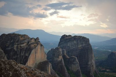 Scenic view of mountains against cloudy sky