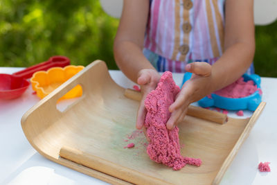 Close-up of woman preparing food on cutting board