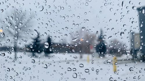 Full frame shot of wet glass window in rainy season