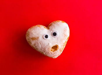 Close-up of heart shape against red background