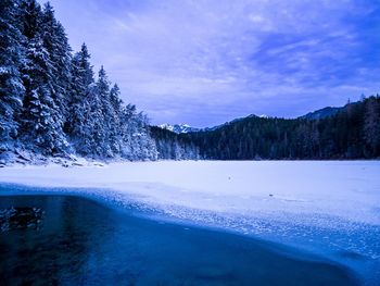 Scenic view of frozen lake against sky during winter