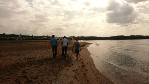 Rear view of man standing on beach