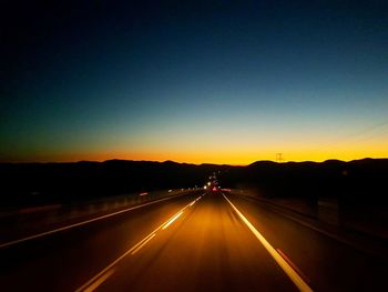 Highway against sky during sunset