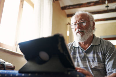 An old man using a tablet. concept elderly