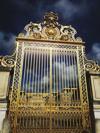 Low angle view of illuminated building against cloudy sky