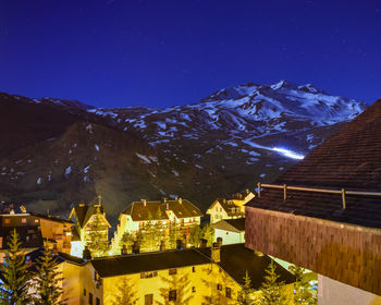 Snow blower working at night in a ski resort in half snowy mountain in pyrenees, spain