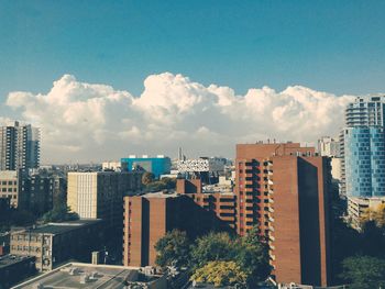 Buildings against blue sky and clouds