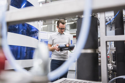 Man holding control in factory shop floor