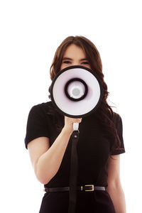 Midsection of woman holding umbrella standing against white background