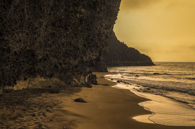 Scenic view of beach against sky during sunrise in cabo de gata nature park, spain