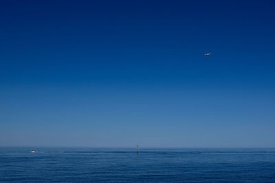 Scenic view of sea against clear blue sky