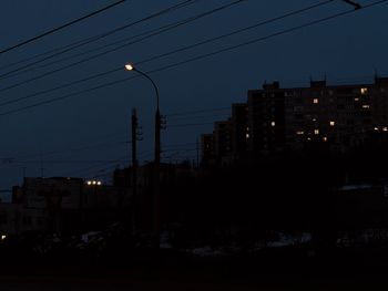 Illuminated buildings against sky at night