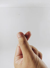 Close-up of person hand against white background