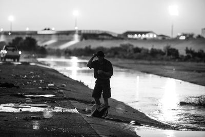 Rear view of woman standing at night