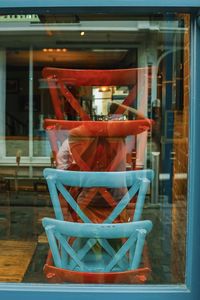 Close-up of empty chairs against window