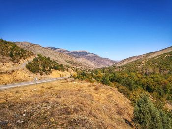 Scenic view of mountains against clear blue sky