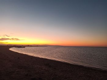 Scenic view of beach against sky during sunset