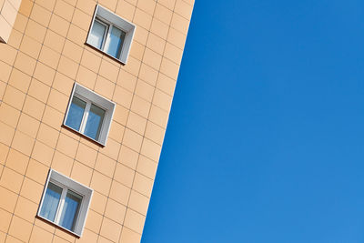 Low angle view of building against clear blue sky