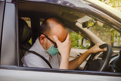 Portrait of man sitting in car