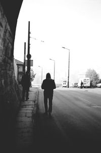 Rear view of people walking on street