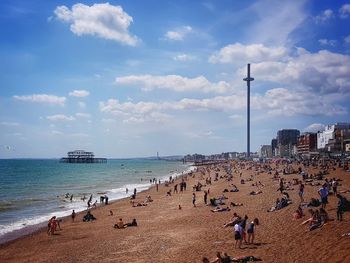 People at beach against blue sky