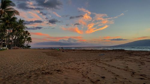 Scenic view of beach against sky during sunset