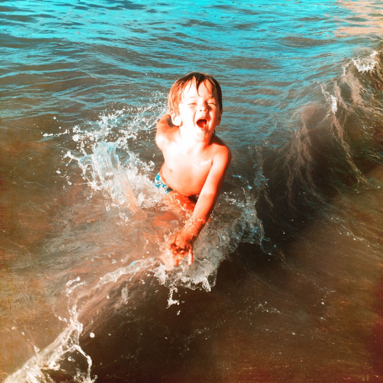 PORTRAIT OF HAPPY BOY IN WATER