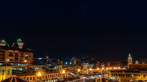 High angle view of buildings lit up at night