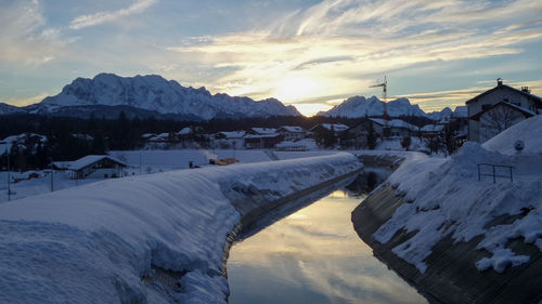 Scenic view of snowcapped mountains against sky during sunset