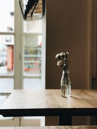 Flower vase on table in cafe