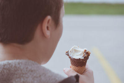 Rear view of boy eating ice cream cone