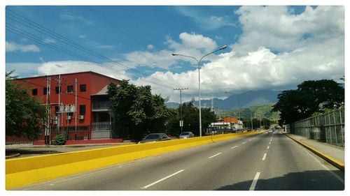 View of road against cloudy sky