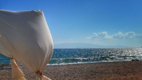 Fabrics at beach against sea