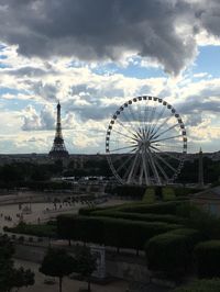 Ferris wheel against cloudy sky