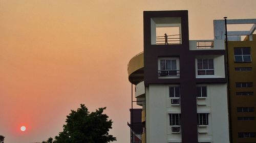 Low angle view of built structure at sunset