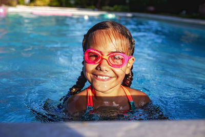 Portrait of young man swimming in pool